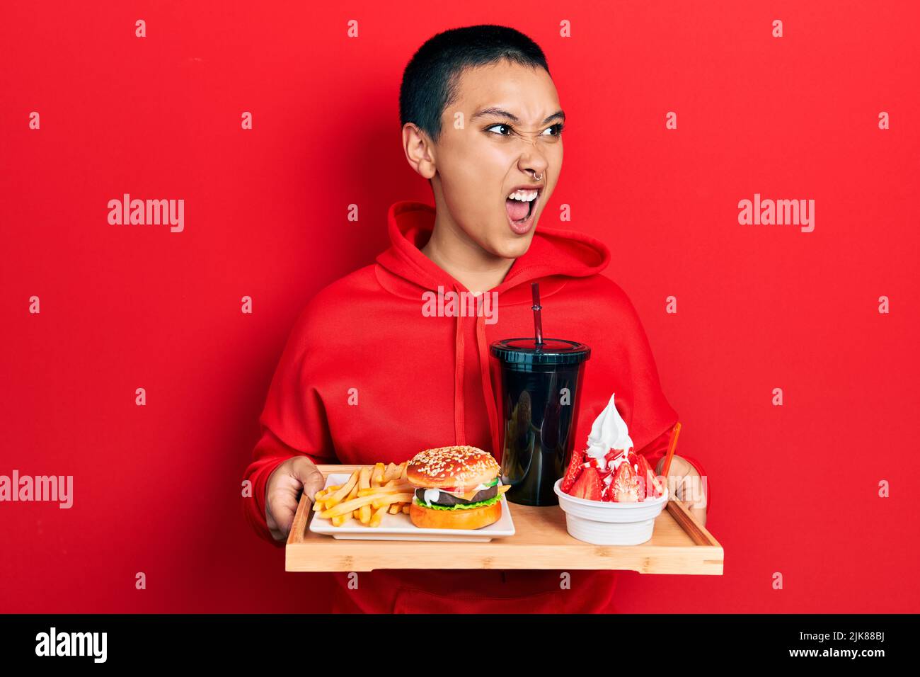 Beautiful Hispanic Woman With Short Hair Eating A Tasty Classic Burger