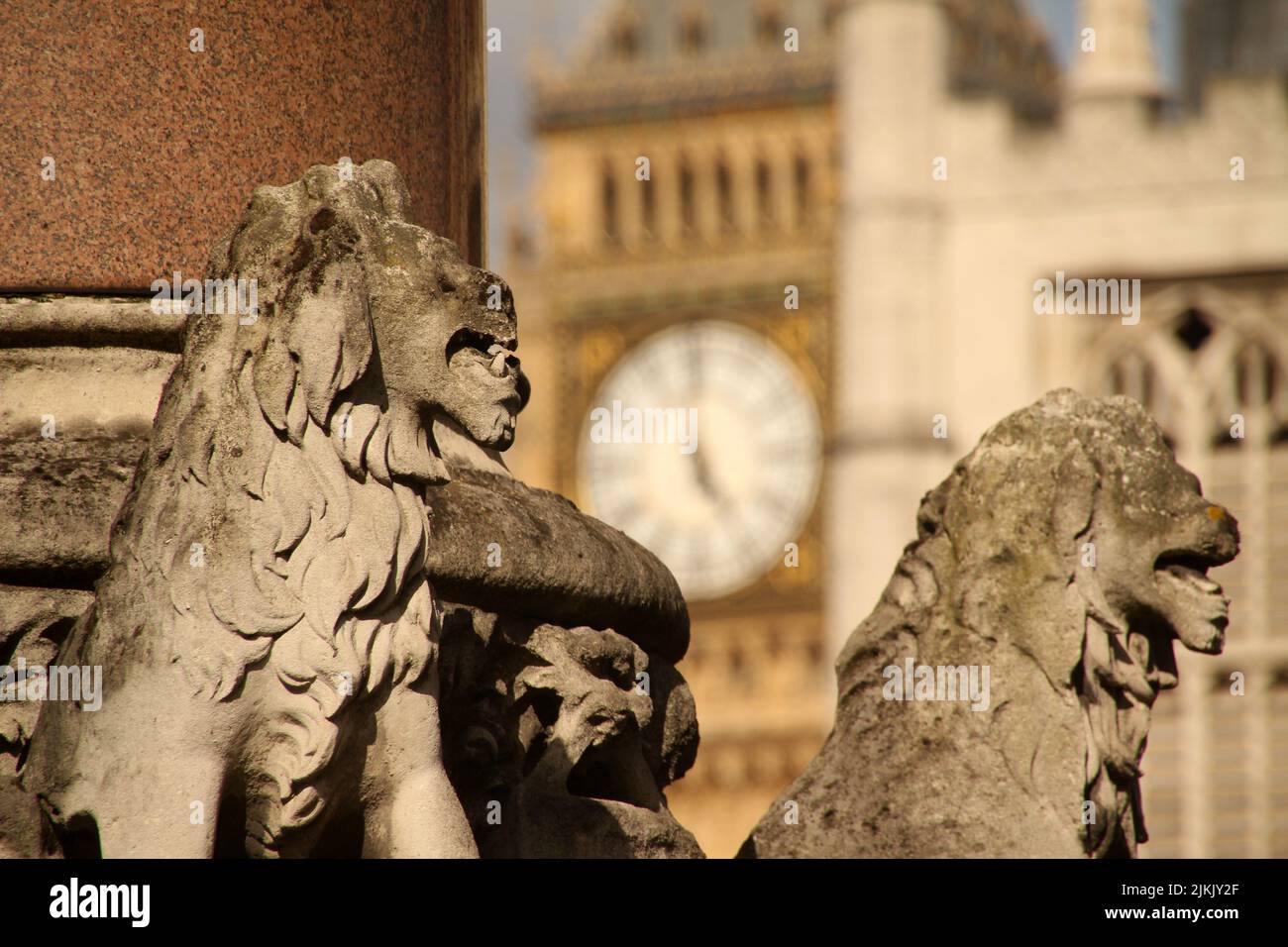 A Stone Sculptures Of Lions In London Square And Big Ben Tower In The