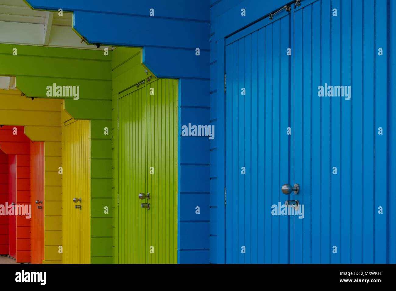 A Close Up View Of Colorful Wooden Beach Huts On The Beach Of