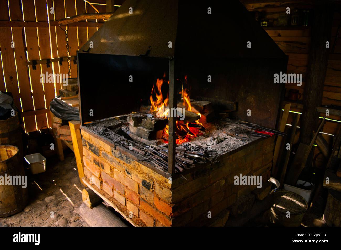 Interior Of An Old Forge Bright Fire Burning In The Furnace Forge