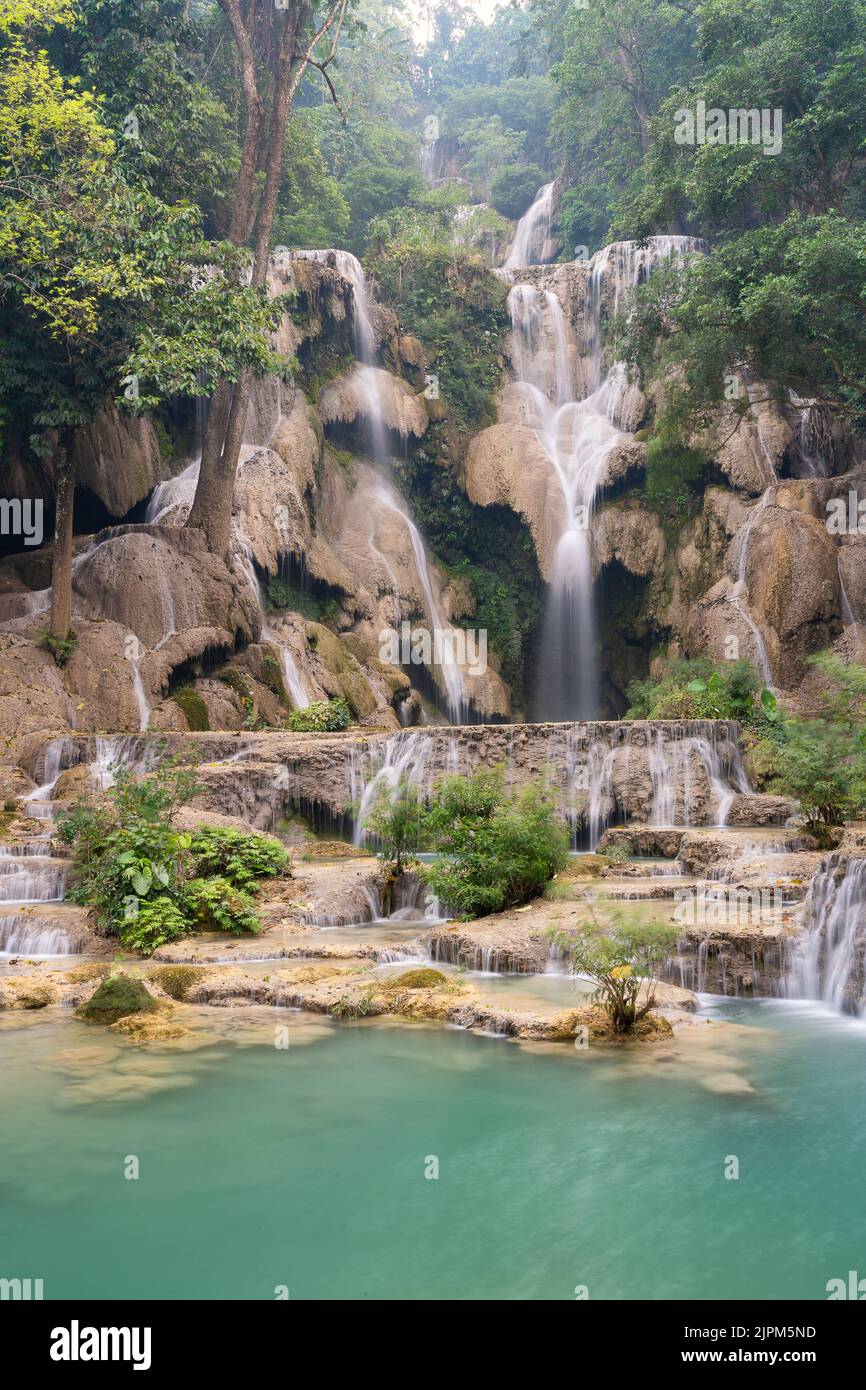 A Vertical Of Kuang Si Waterfall In A Forest In Luang Prabang Laos