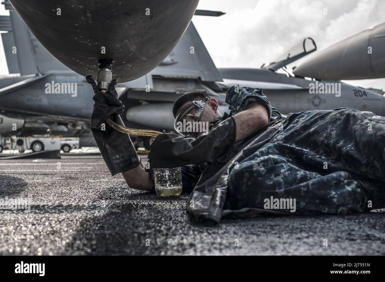 U S Navy Aviation Structural Mechanic 3rd Class Takes A Fuel Sample