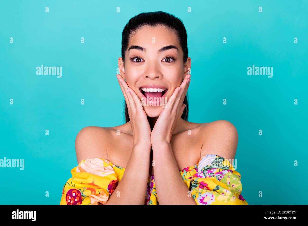 Photo Of Impressed Millennial Brunette Lady Hands Cheeks Wear Yellow