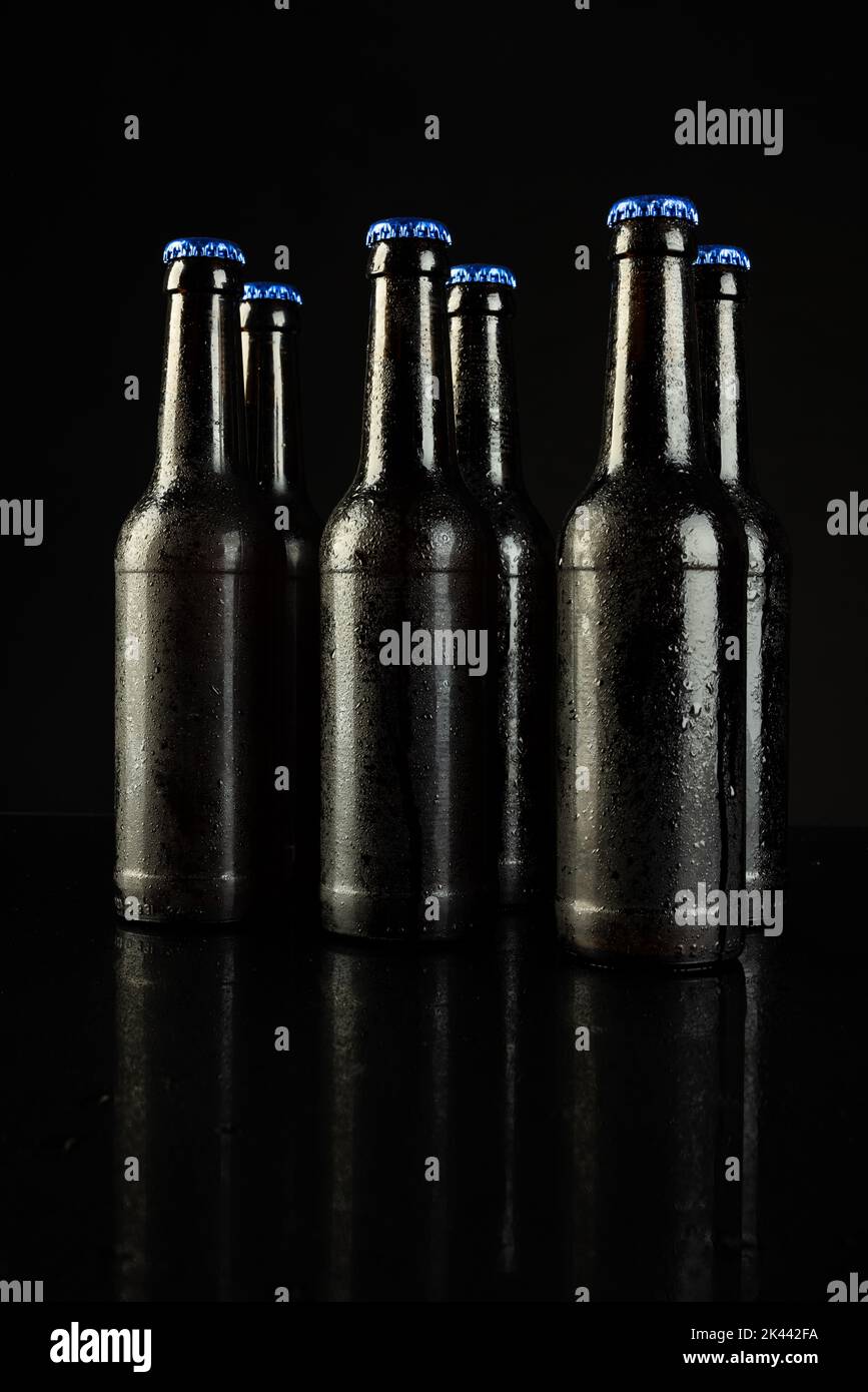 Image Of Six Beer Bottles With Blue Crown Caps With Copy Space On