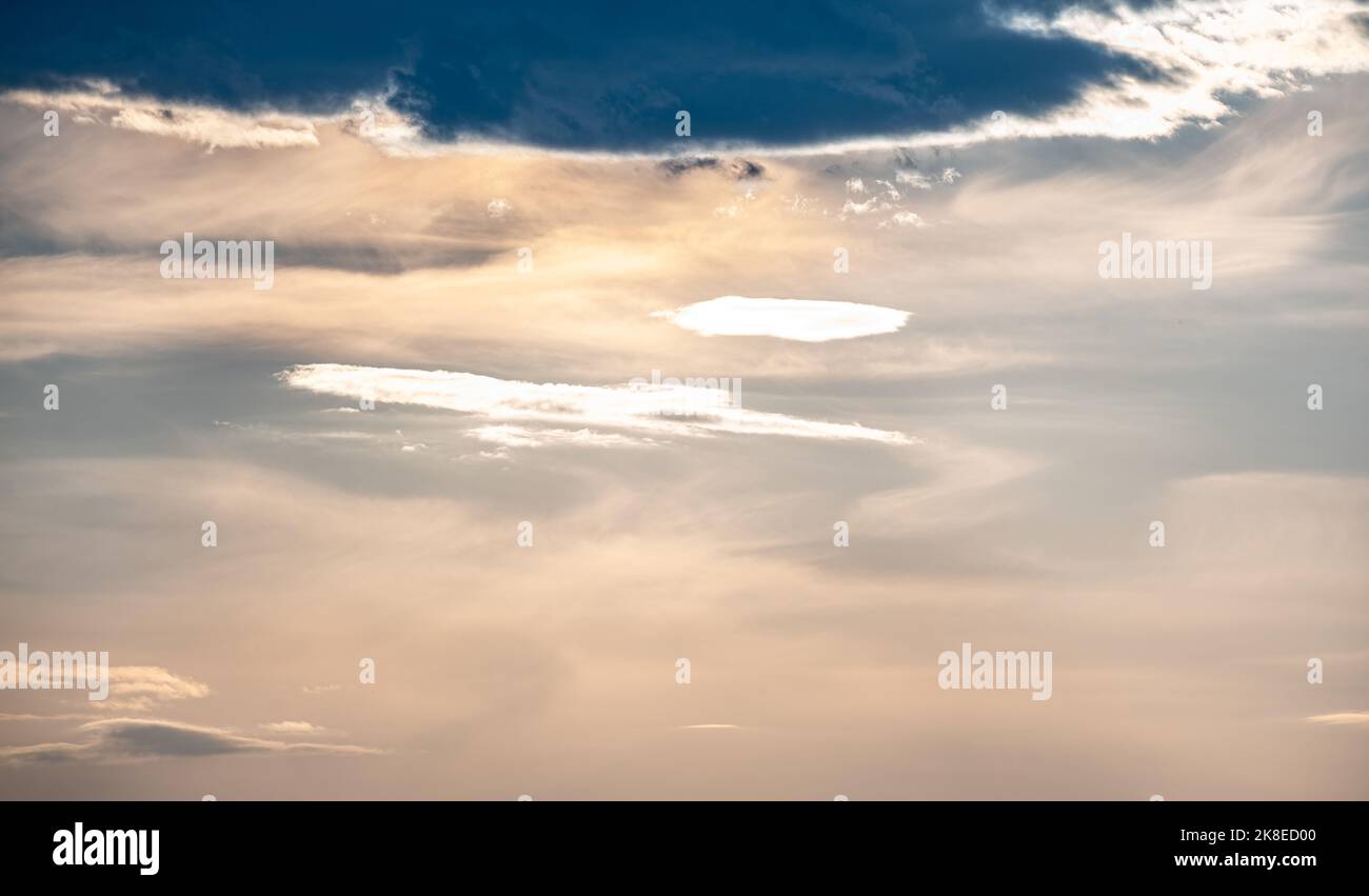 A Sky With Clouds Obscuring The Sun As It Approaches The Horizon