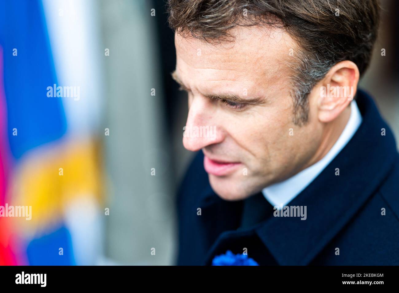 French President Emmanuel Macron Lays A Wreath Of Flowers During A