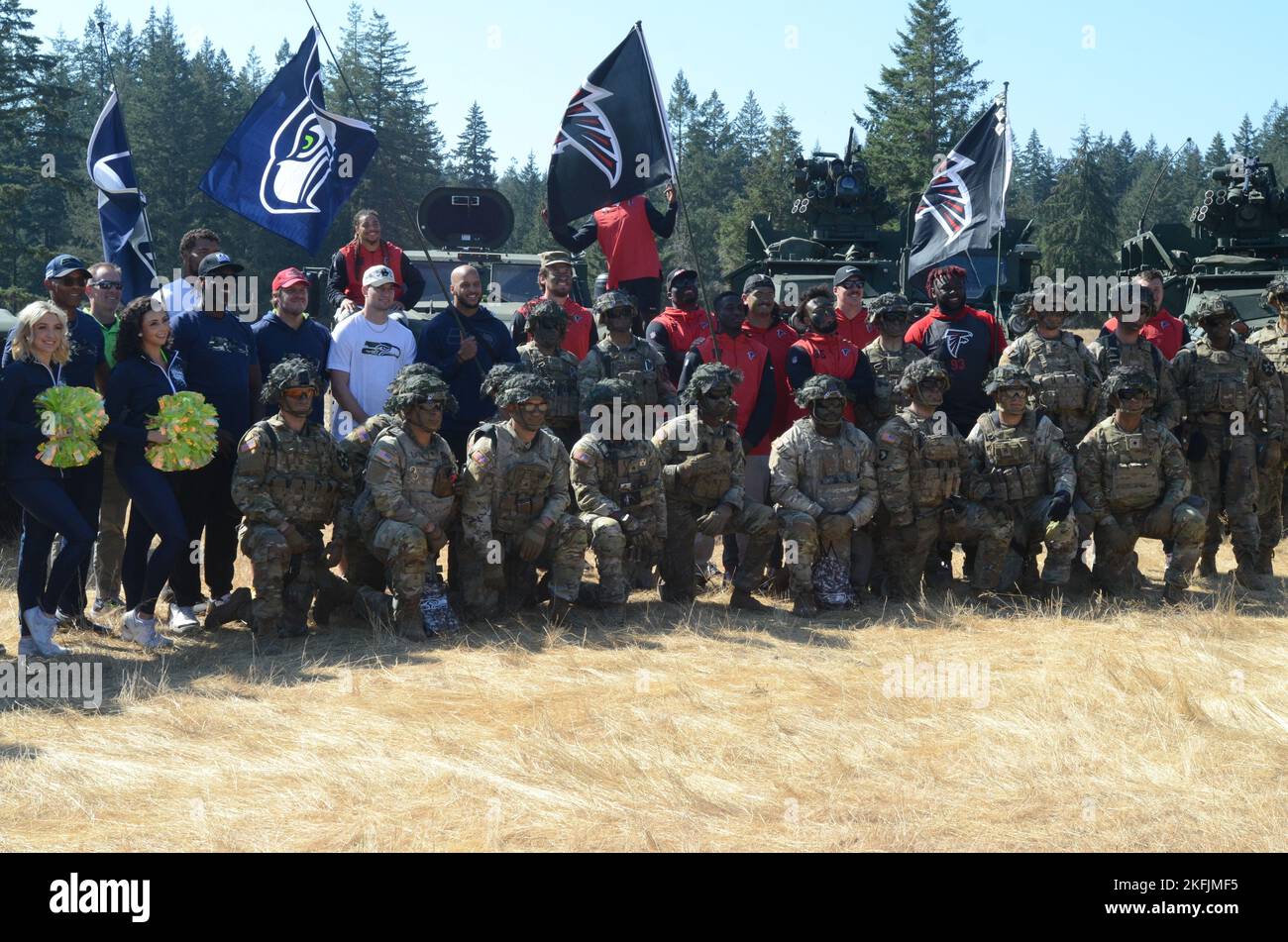 Seattle Seahawks And Atlanta Falcons Players Pose With Joint Base Lewis