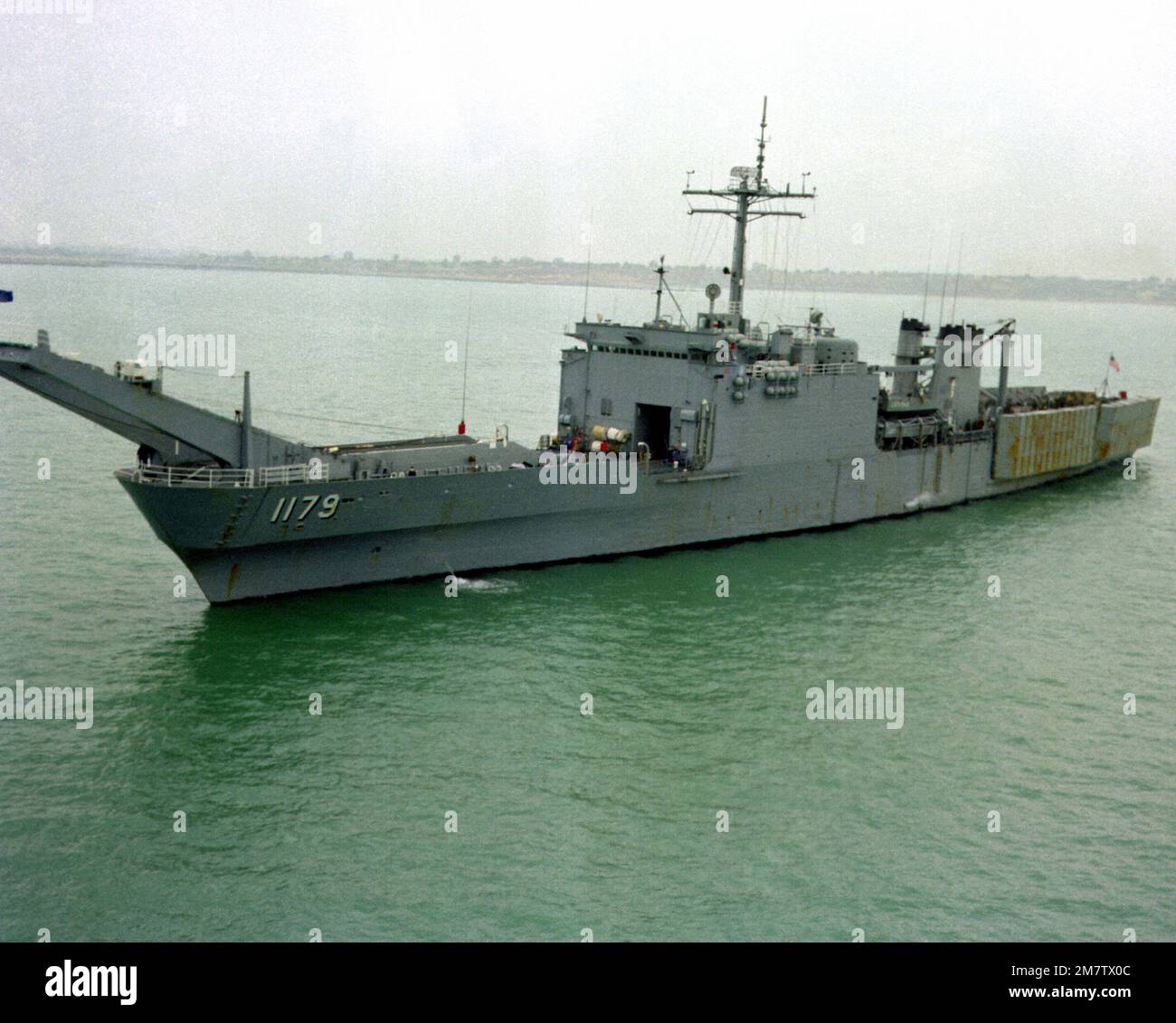 A Port Bow View Of The Tank Landing Ship USS NEWPORT LST 1179 Leaving