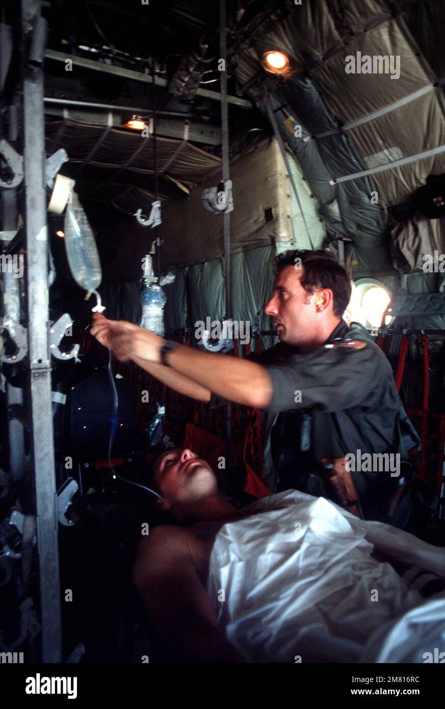 A Member Of The St Aeromedical Evacuation Squadron Checks A Wounded