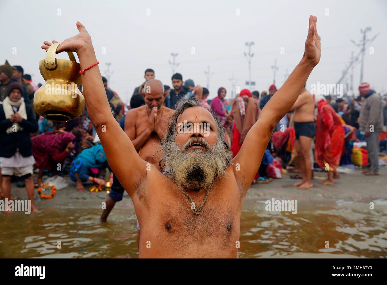 A Hindu Devotee Offers Prayers While Taking A Holy Dip At The Sangam