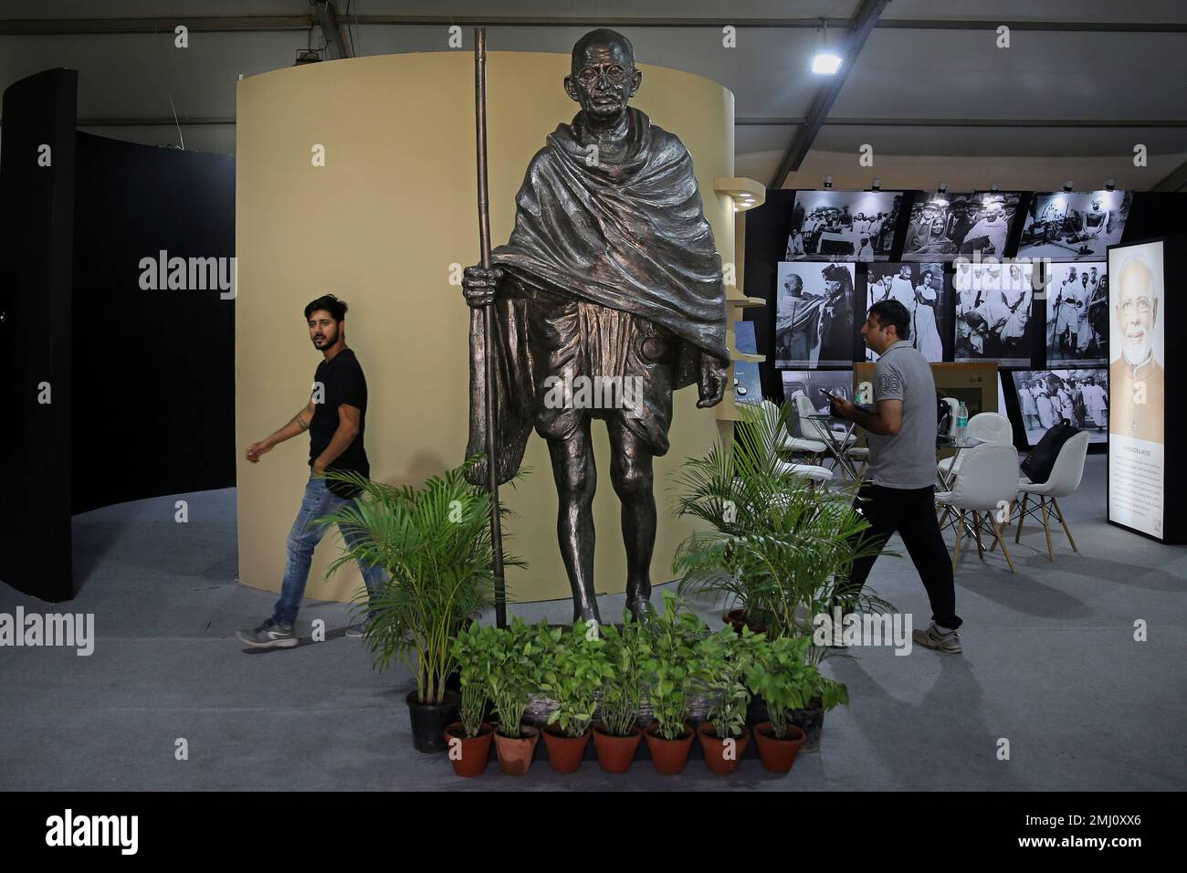 Indians Walk Past A Statue Of India S Independence Leader Mahatma