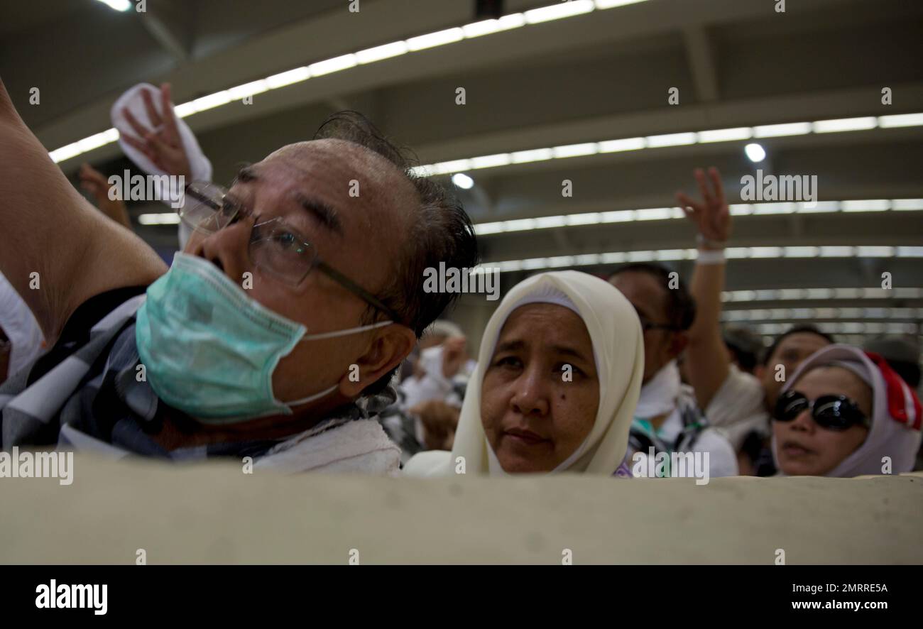 Muslim Pilgrims Cast Stones At The Huge Stone Pillar In The Symbolic