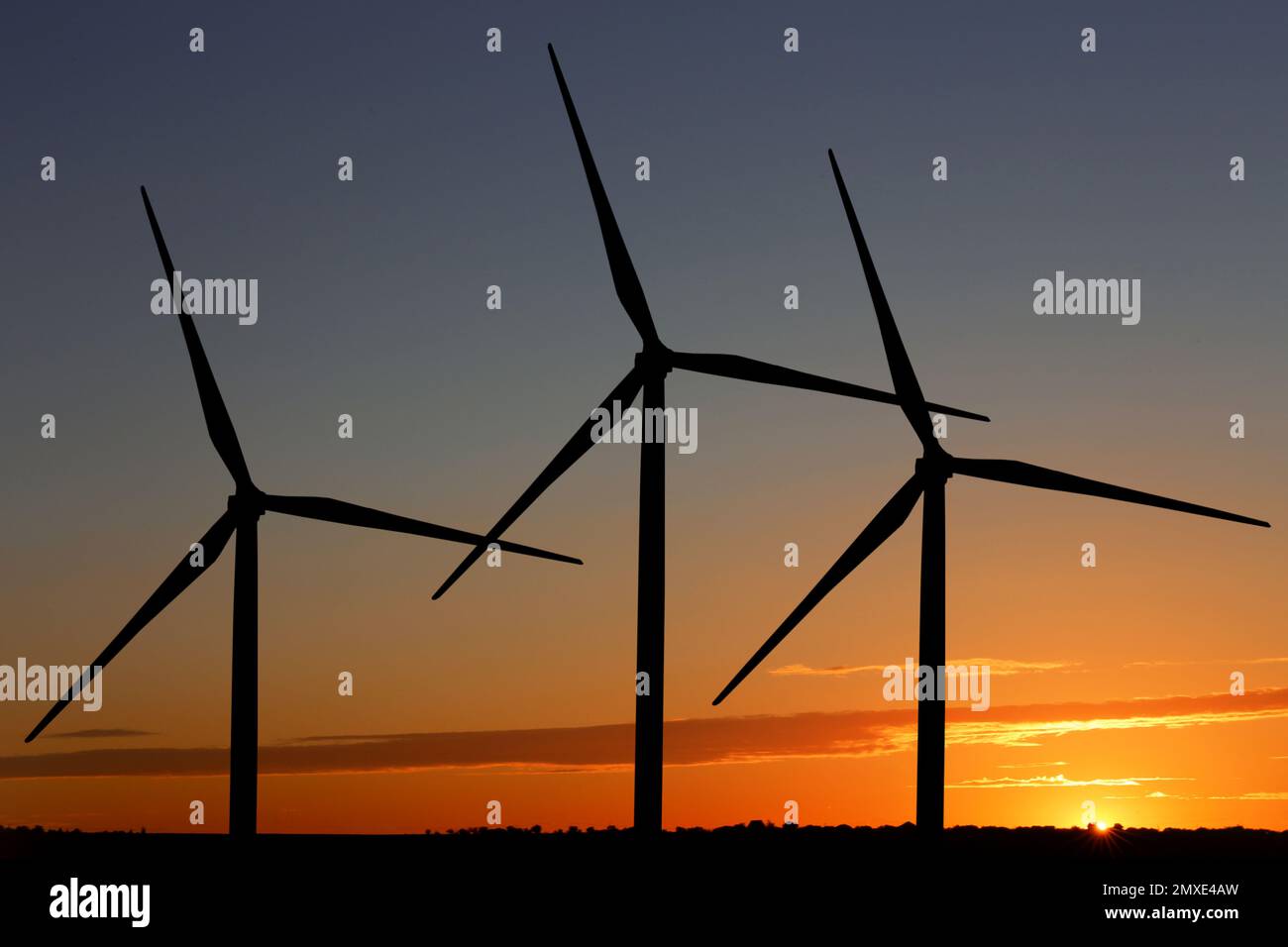 Silhouettes Of Wind Turbines At Sunset Alternative Energy Source Stock