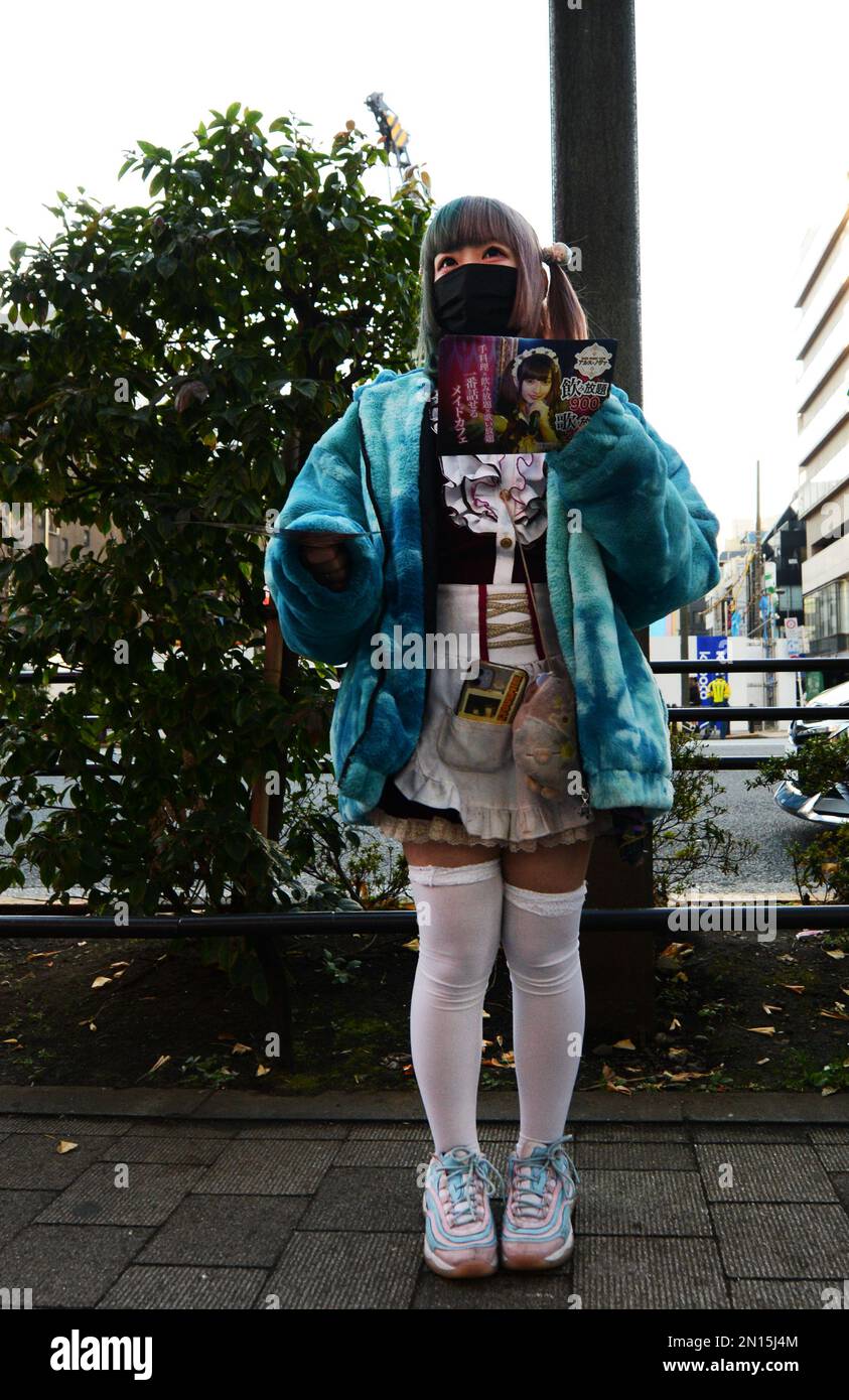 Girls Dressed In French Maid Costumes Handing Out Discount Coupons For