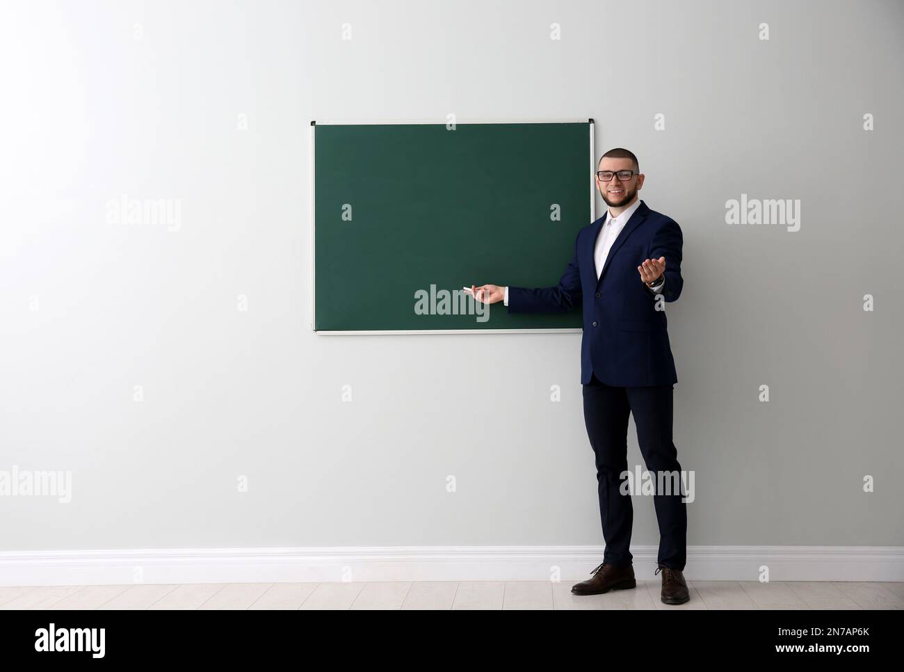 Teacher Near Green Chalkboard With Words Do You Speak English Stock