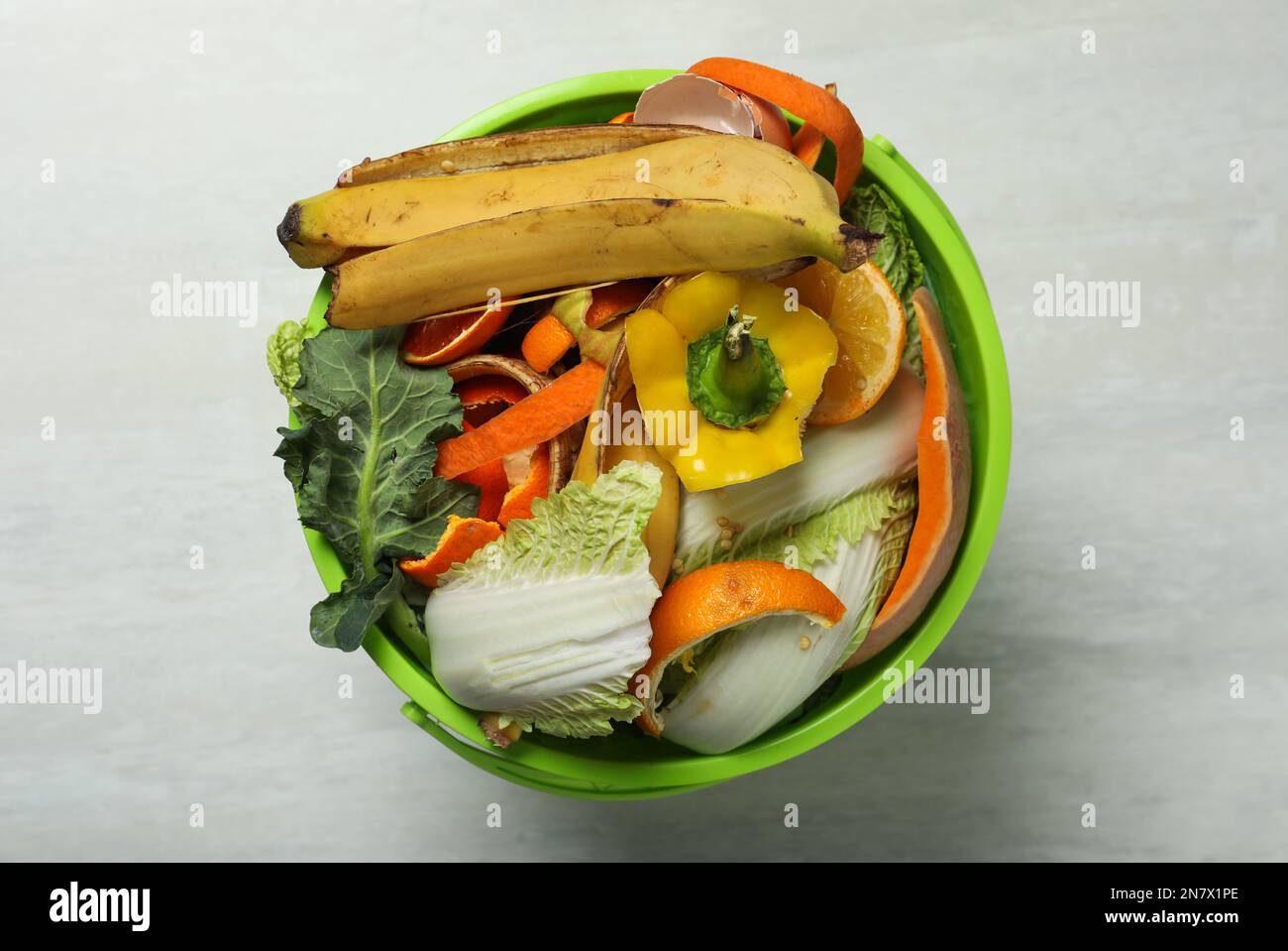 Trash Bin With Organic Waste For Composting On Light Background Top