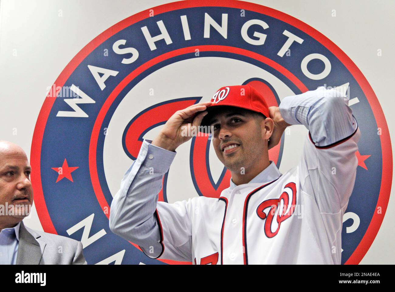 Washington Nationals New Pitcher Gio Gonzalez Right Puts On His Cap