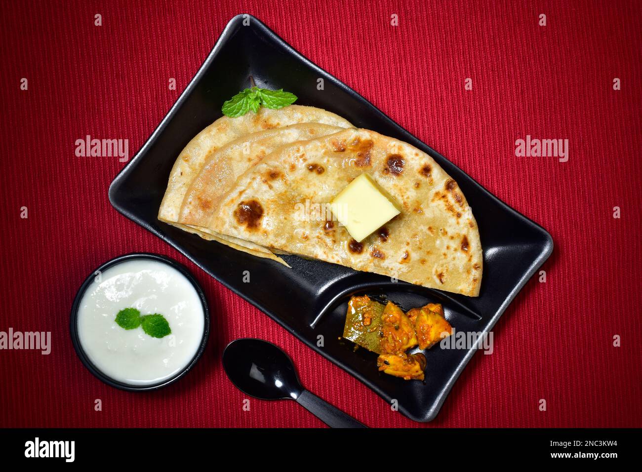 Aloo Paratha Served With Curd And Pickle Stuffed Butter Paratha Stock