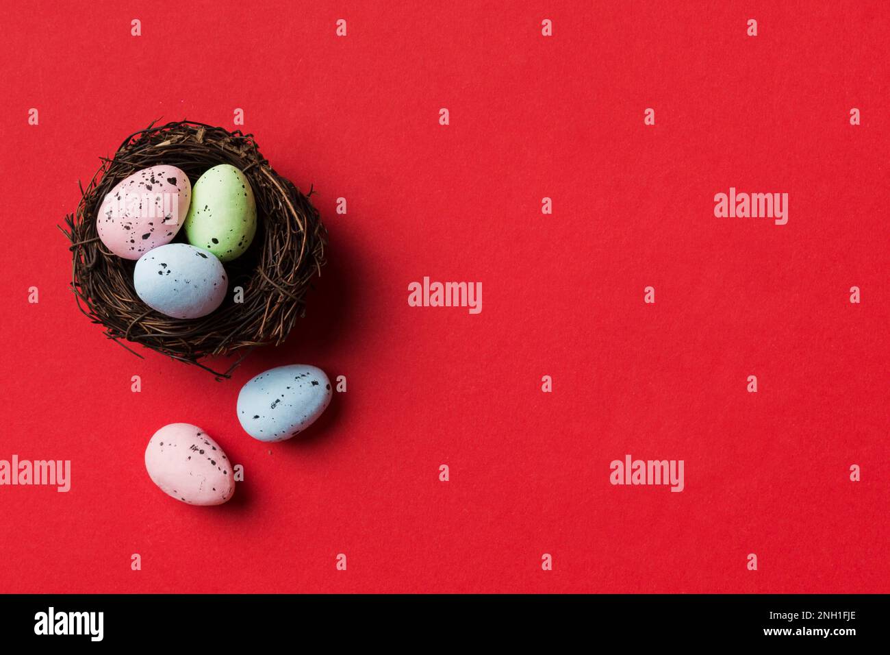 Colorful Easter Eggs In Nest On Table Background With Copy Space Top