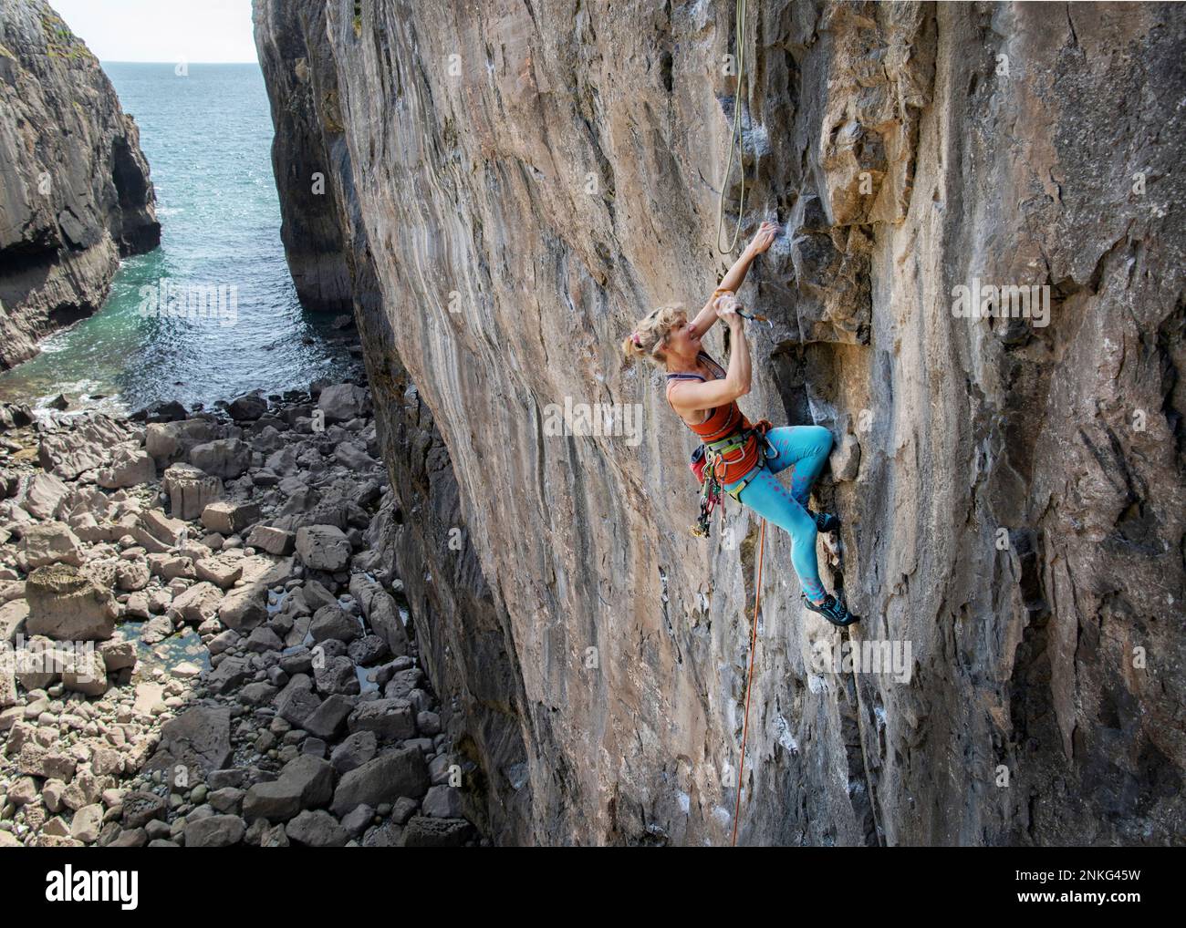 Mature Adventurous Woman Climbing On Rocky Mountain Stock Photo Alamy