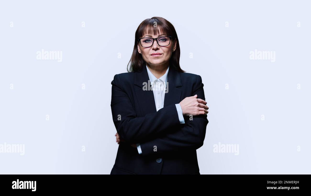 Portrait Of Confident Mature Business Woman In Black Suit On Light