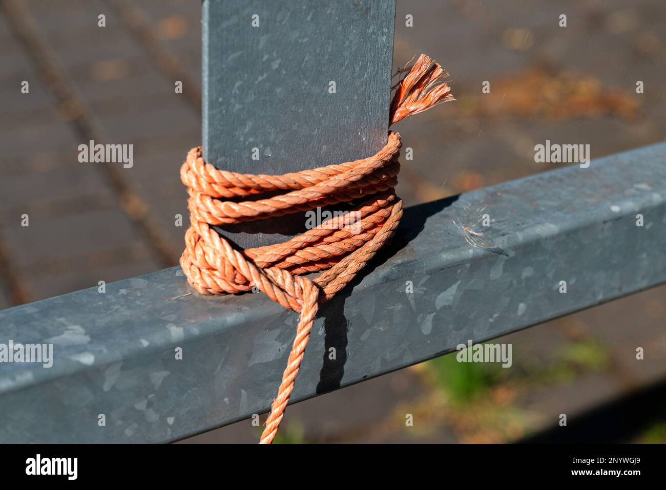 Orange Rope Tied To A Metal Fence Knots On The Iron Beam Close Up