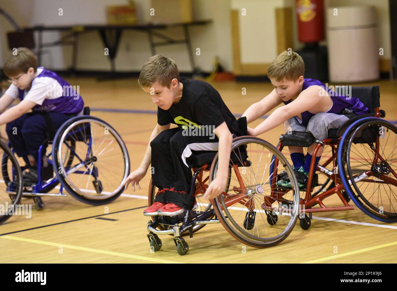 Zachary Armas Drills As Tanner Adkins Pushes His Wheelchair During