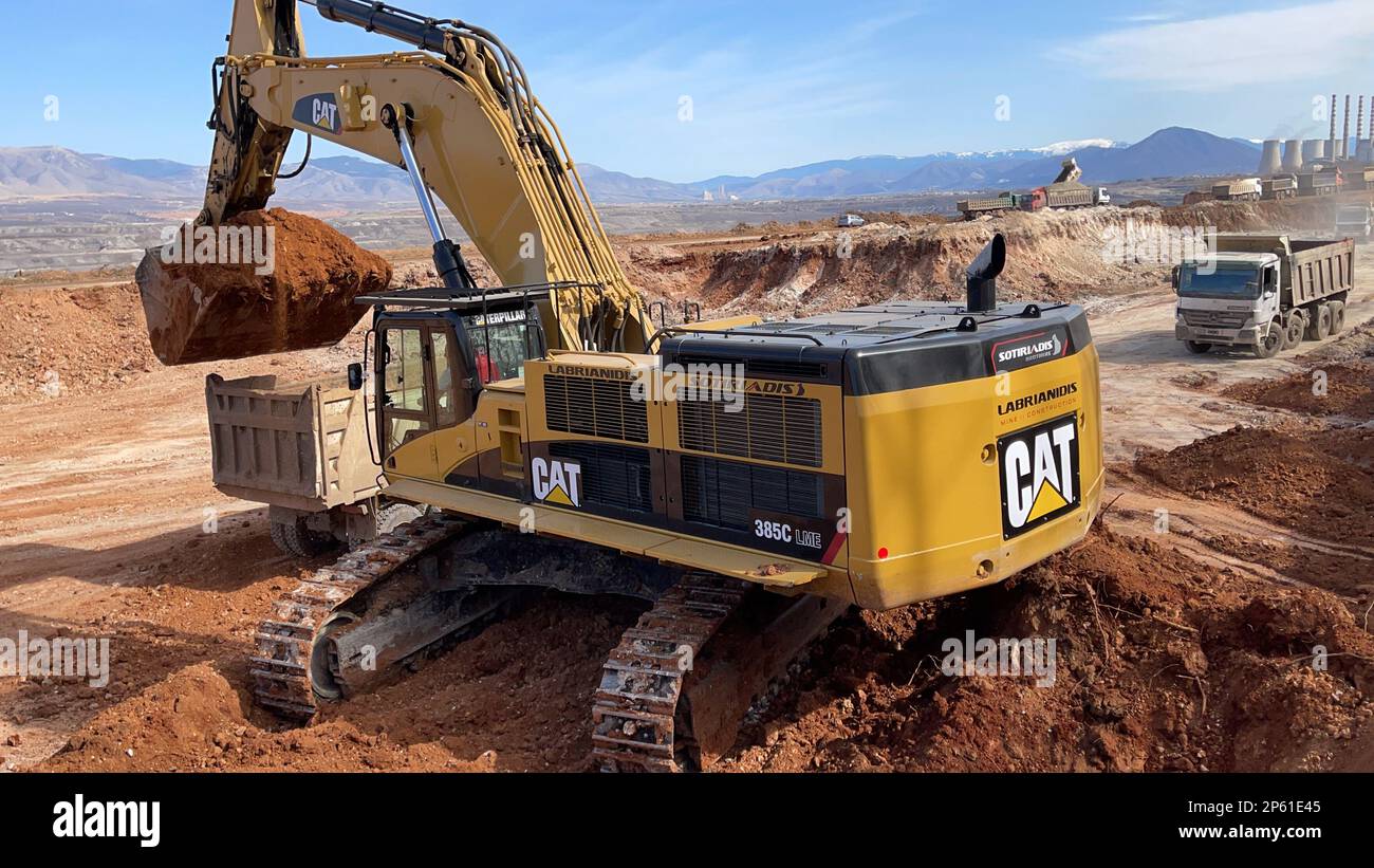 Excavator Working On Huge Mining Site Loading The Trucks Trucks