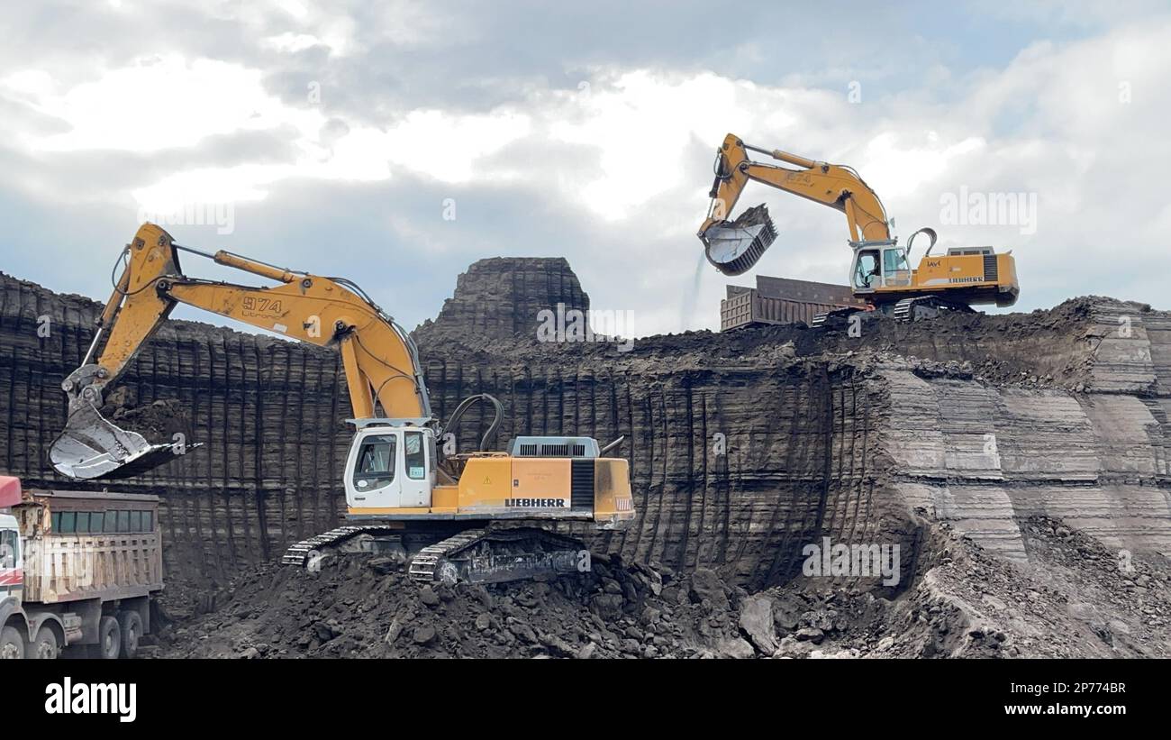 Excavators Working On Huge Mining Site Loading The Trucks Trucks