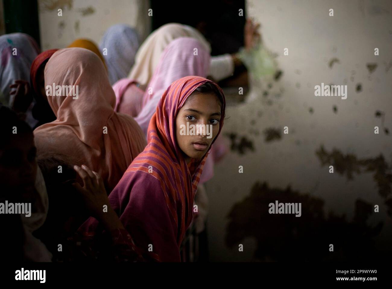 A Pakistani Girl Looks On As She Lines Up During A Food Distribution In