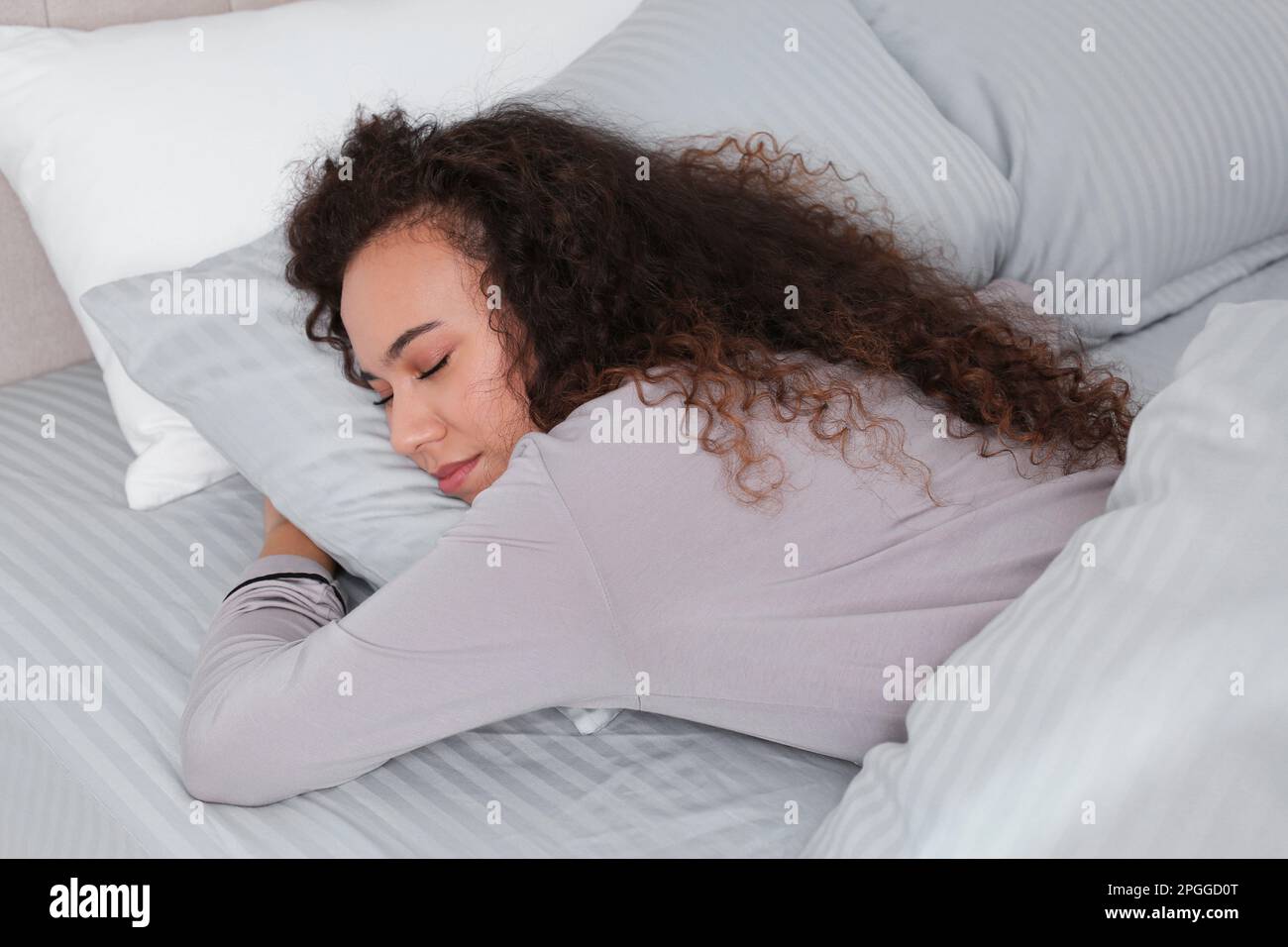 Beautiful African American Woman Sleeping In Bed At Home Stock Photo