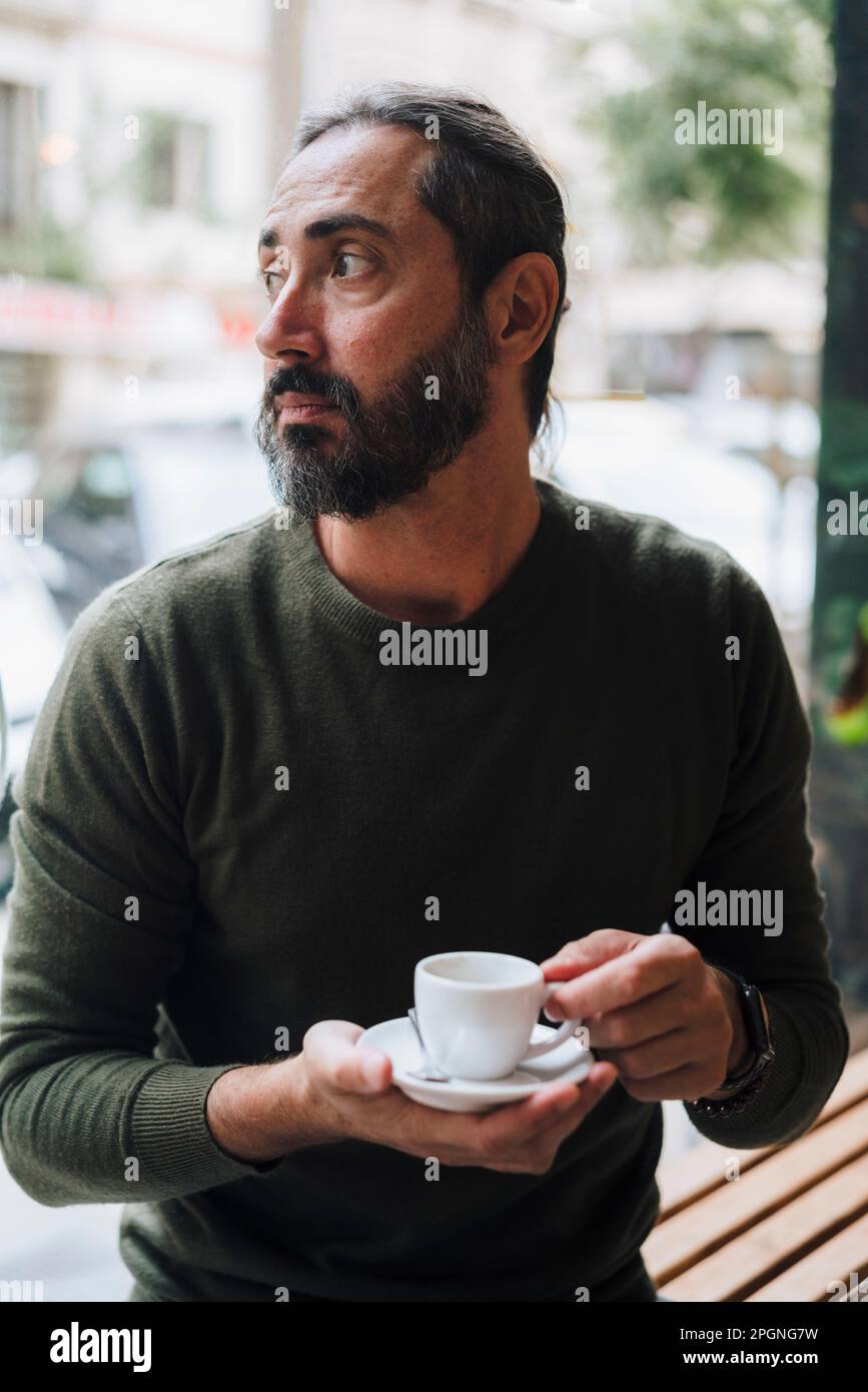 Thoughtful Mature Man Holding Coffee Cup In Cafe Stock Photo Alamy