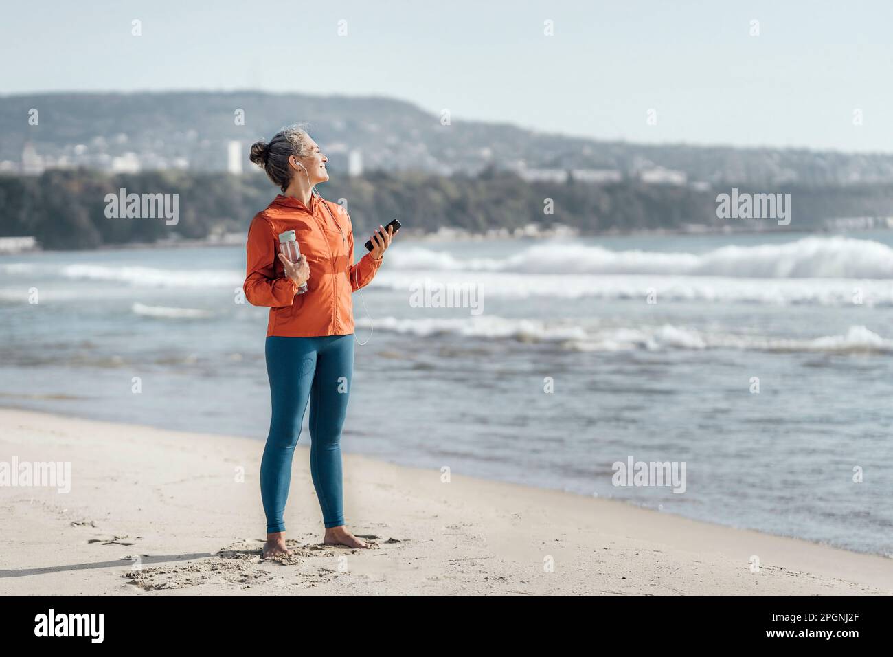 Mature Woman Standing On Sand At Beach Stock Photo Alamy