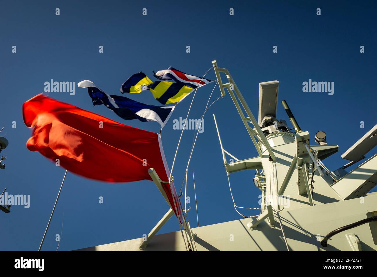 Sailor Raising A Hoist Of Signal Flags Onboard HMCS Margaret Brooke