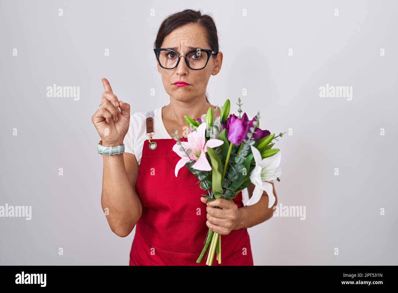 Middle Age Brunette Woman Wearing Apron Working At Florist Shop Holding