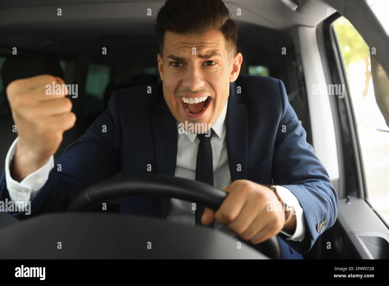 Emotional Man Yelling In Car Aggressive Driving Behavior Stock Photo