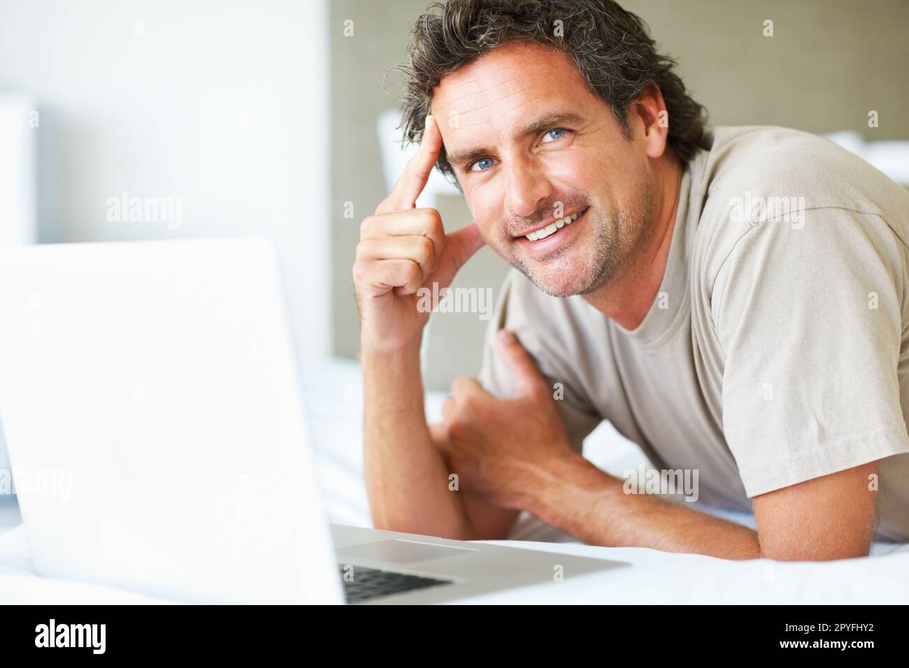 Confident Man With Laptop Relaxed Mature Man With Laptop Lying In Bed