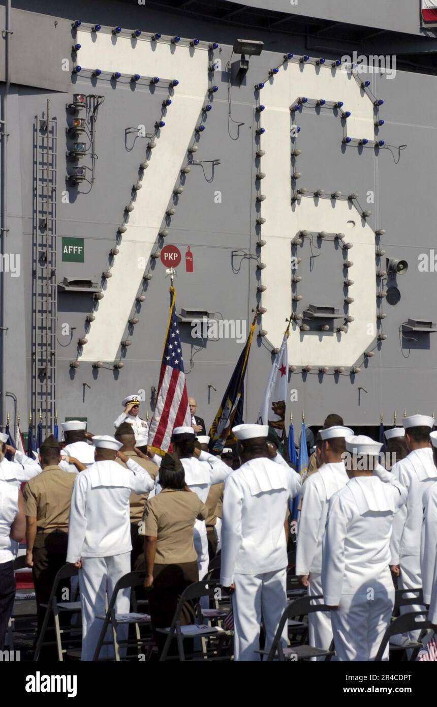 US Navy Sailors And Marines Render Honors To The National Ensign At The