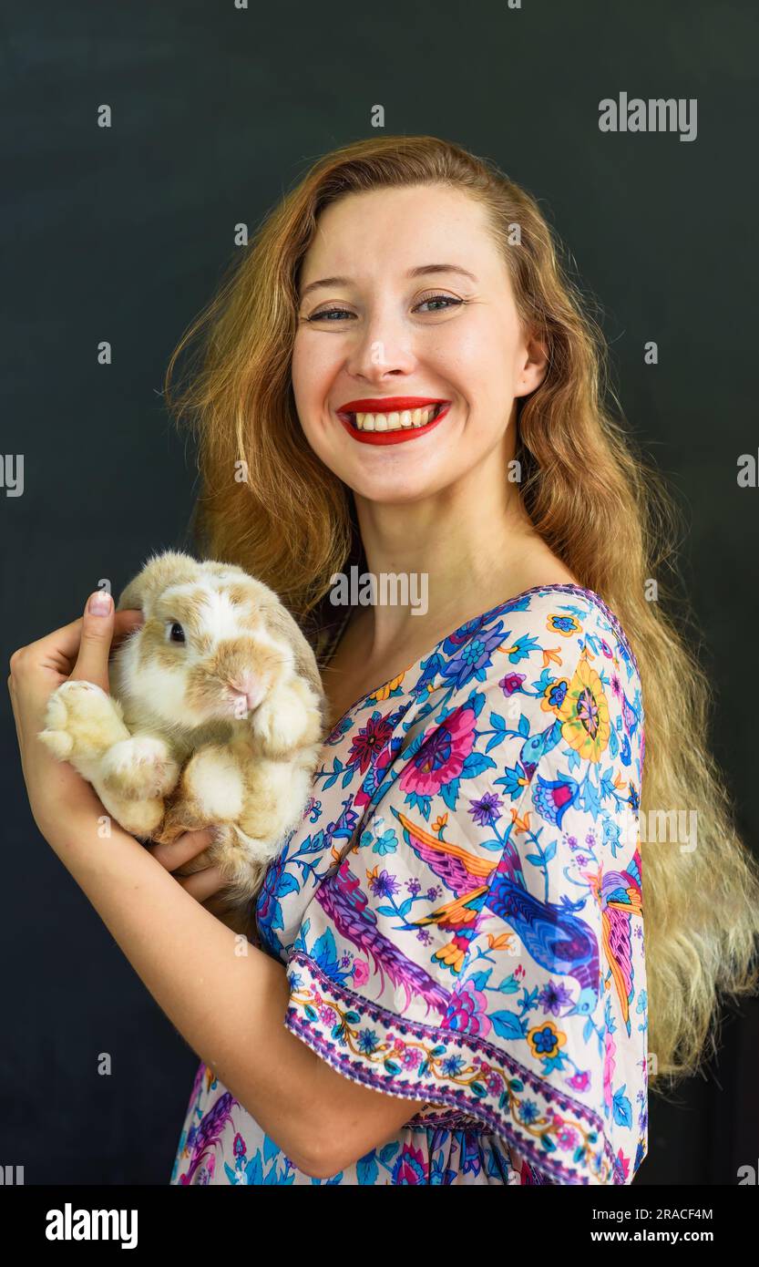 Beautiful Russian Woman With Long Blond Hair Holding A Rabbit Pet In