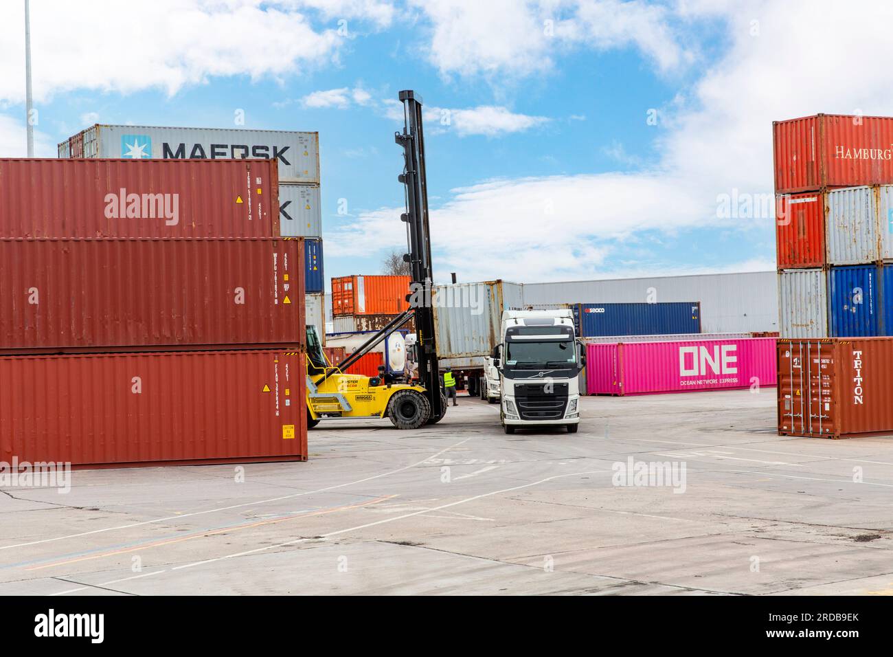 Shipping Containers Being Loaded Onto Hgv Vehicle At An Inland