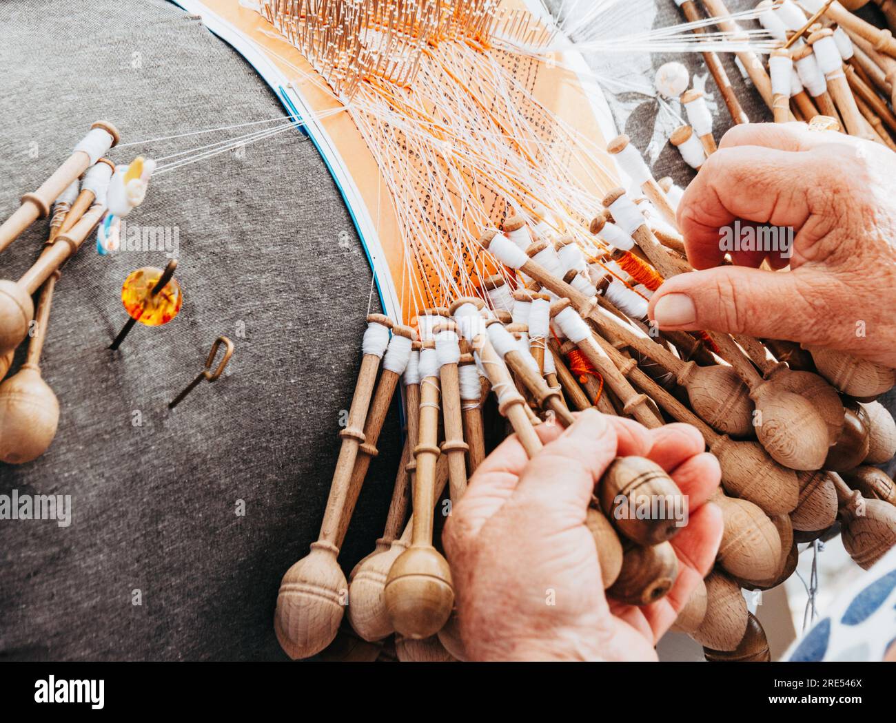 Hands Of A Woman Weaving Bobbin Lace In A Workshop Lacemaker Woman At