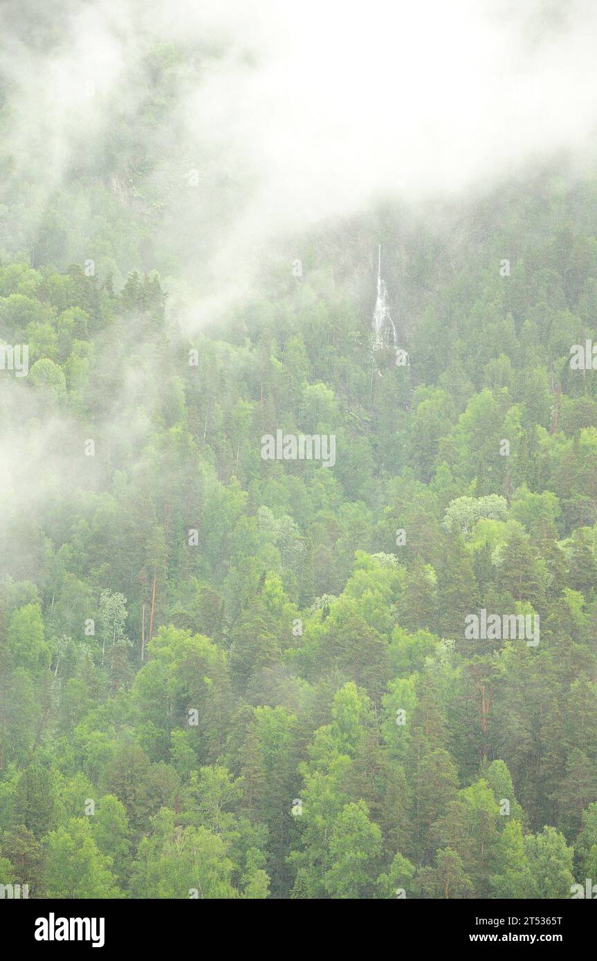 Partially Hidden By Dense Clouds The Slope Of A High Mountain