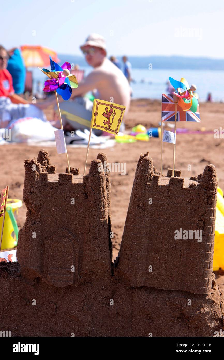 Two Sand Castles On The Beach During Summer With A British And Welsh