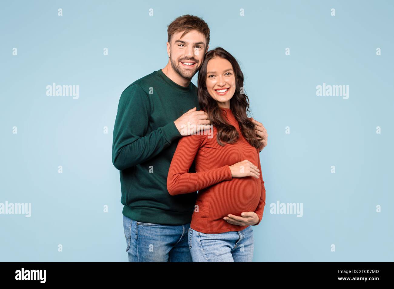 Expectant Couple Smiling Man Embracing Pregnant Partner Stock Photo