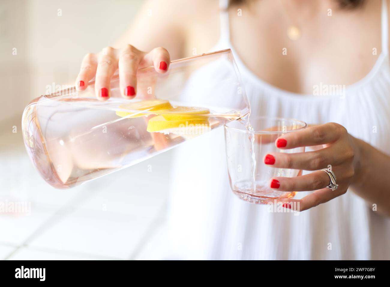 Female Hand Pouring Water Into Glass Stock Photo Alamy