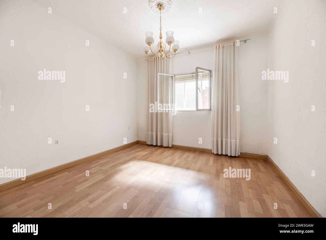 An Empty Room With White Painted Walls Wooden Floor And Open Aluminum