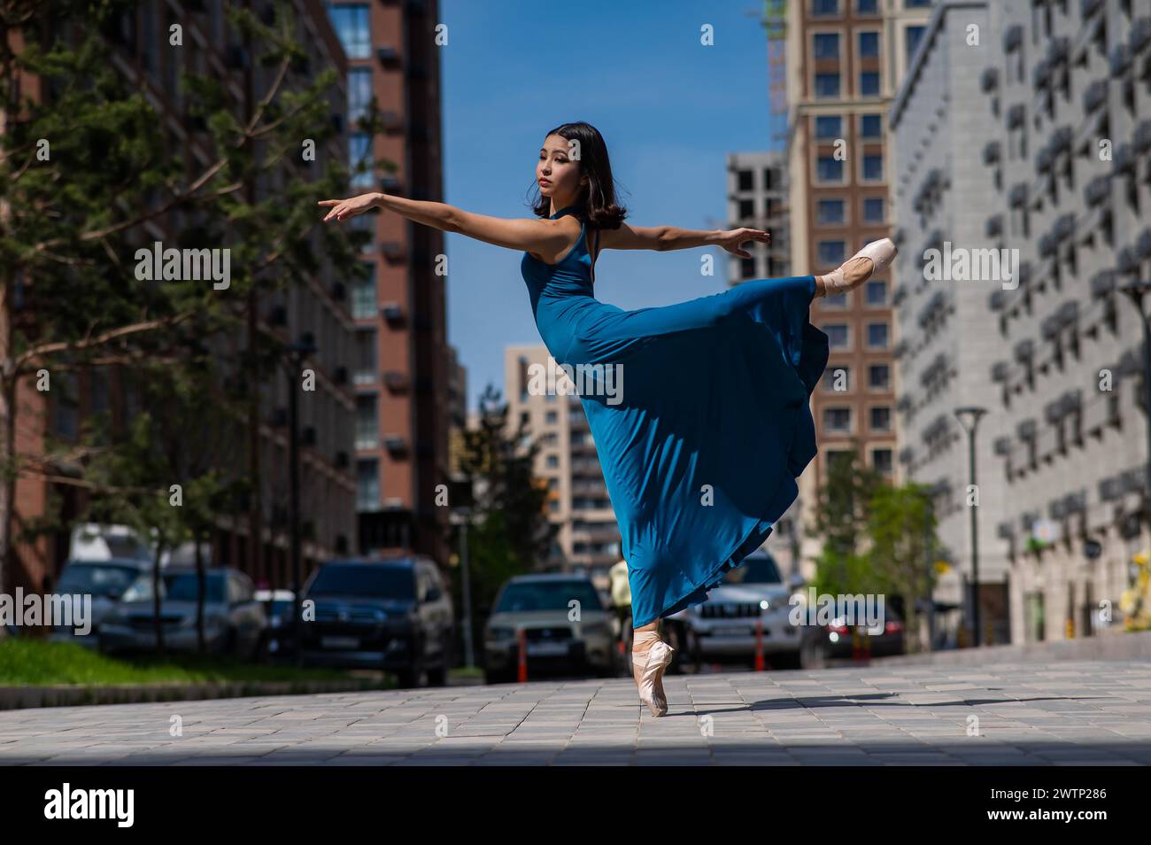 Beautiful Asian Ballerina In Blue Dress Dancing Outdoors Urban