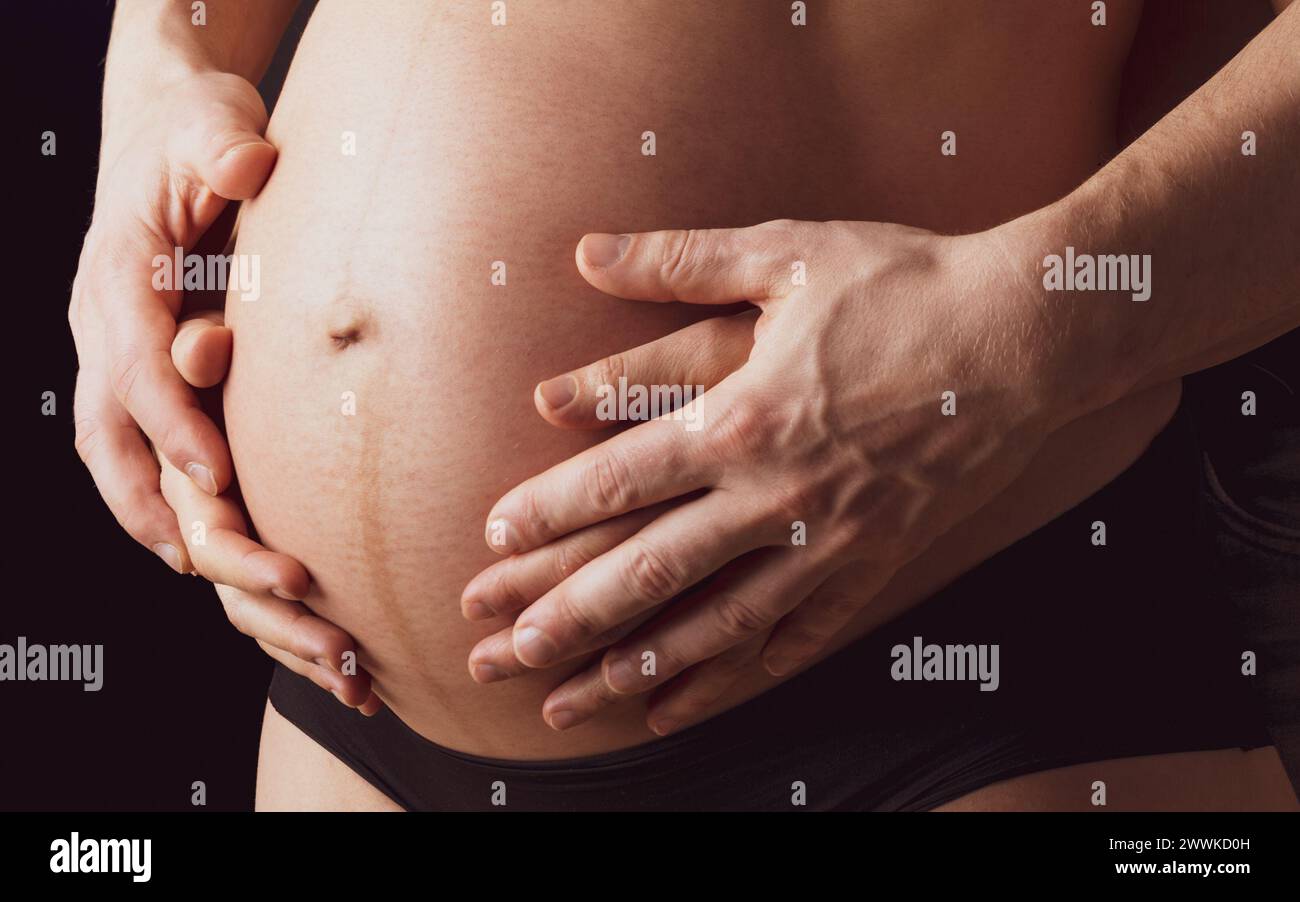 Description Closeup Of Naked Round Belly Of Pregnant Mother In