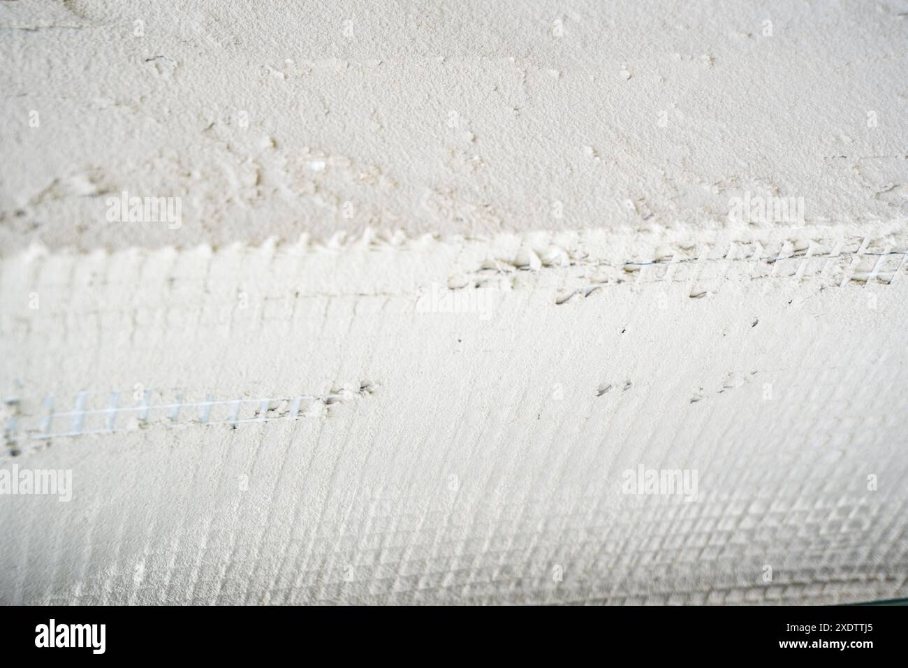 Builder Installing Rigid Styrofoam Insulation Board For Energy Saving