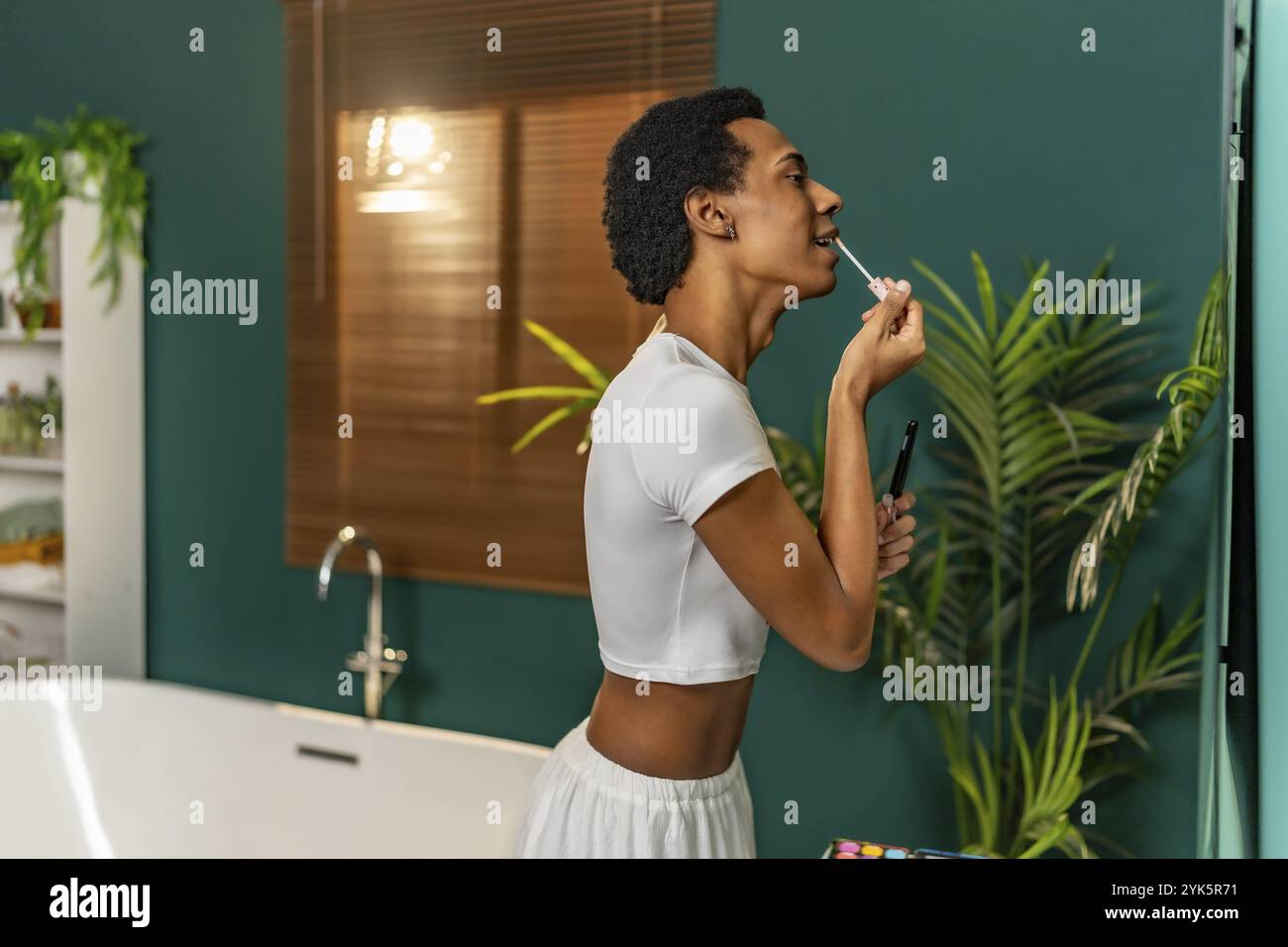 Side View Of A Latin Transgender Gay Man Making Up In The Bathroom Stock Photo Alamy